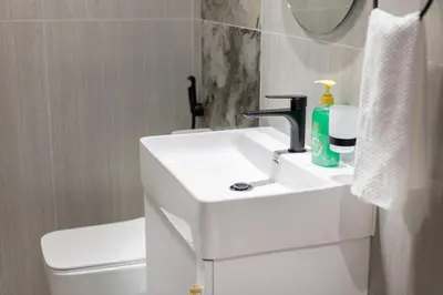 a white bathroom with a sink and a toilet at Luxury 1 BHK in Al Barsha by Opalz by Danube 1607 in Dubai