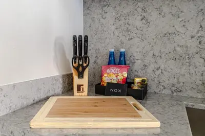 a cutting board sitting on top of a counter with scissors at Luxury one bed flat in Dubai Harbour in Dubai