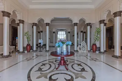 a lobby with a table with flowers on it at 2BHK in Palm Jumeirah Sea View Grandeur Residence 301 in Dubai