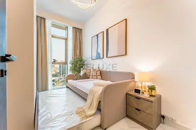 a living room with a couch and a window at Community View 1BR, Perfectly Located Near the Park, Just a Short Drive Away from Dubai Top Tourist Attractions, Adhara Star, Arjan by Deluxe Holiday Homes in Dubai