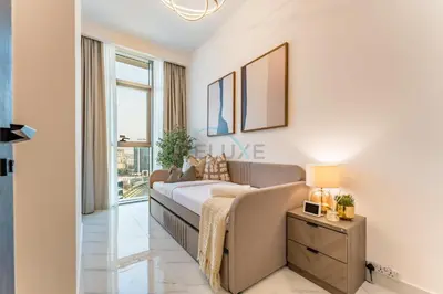 a living room with a couch and a window at Community View 1BR, Perfectly Located Near the Park, Just a Short Drive Away from Dubai Top Tourist Attractions, Adhara Star, Arjan by Deluxe Holiday Homes in Dubai