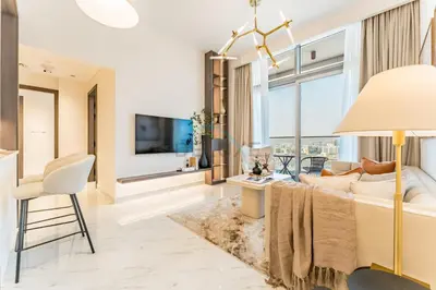 a living room with a couch and a tv at Community View 1BR, Perfectly Located Near the Park, Just a Short Drive Away from Dubai Top Tourist Attractions, Adhara Star, Arjan by Deluxe Holiday Homes in Dubai
