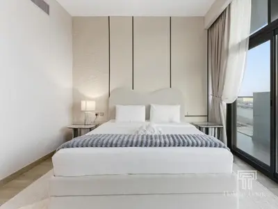 a bedroom with a large white bed and a window at Brand New 2 Bed Contemporary Apt-Gym Pool Access in Dubai