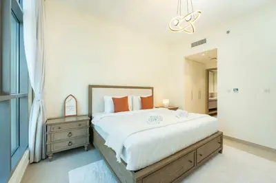 a bedroom with a large bed and a mirror at PVH - Acacia C - Spacious 1BR with Direct Dubai Hills Park Access in Dubai