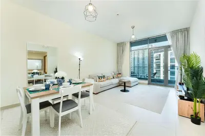 a living room with a table and a couch at PVH - Acacia C - Spacious 1BR with Direct Dubai Hills Park Access in Dubai