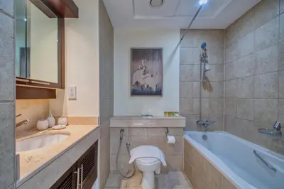 a bathroom with a tub and a toilet and a sink at GlobalStay Luxury Apartments The Residences Tower 8 Downtown Dubai in Dubai