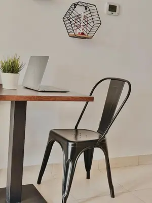 a black chair sitting in front of a desk with a laptop at Cozy Studio in Downtown, Short walk to Burj Khalifa in Dubai