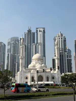 a white mosque in front of a large city at Cozy Studio in Downtown, Short walk to Burj Khalifa in Dubai