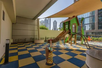 a room with a playground with a checkered floor at Cozy Studio in Downtown, Short walk to Burj Khalifa in Dubai