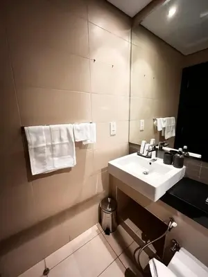 a bathroom with a sink and a mirror at Elegant Studio, Marina access, Queen & Sofabed in Dubai