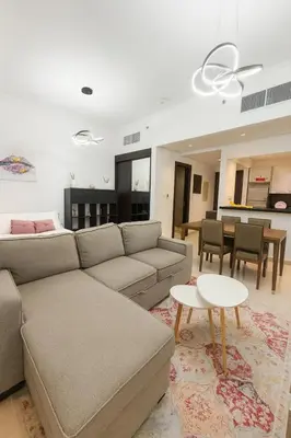 a living room with a couch and a table at Elegant Studio, Marina access, Queen & Sofabed in Dubai