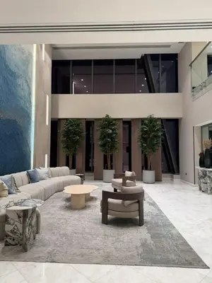a living room with couches and tables in a building at Elegant Studio, Marina access, Queen & Sofabed in Dubai