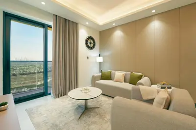 a living room with a couch and a table at Brand New 1-BR with Marina and JLT Balcony Views in Dubai