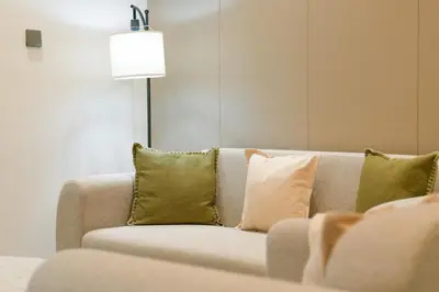 a couch with green pillows in a living room at Brand New 1-BR with Marina and JLT Balcony Views in Dubai