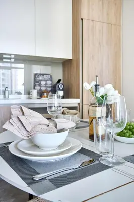 a table with plates and wine glasses on it at Frank Porter - Peninsula One in Dubai