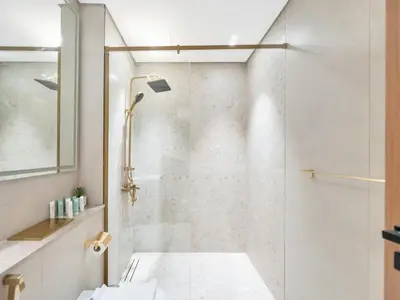 a bathroom with a shower with a glass door at Premium 2BD with Balcony Pool & Gym in Dubai