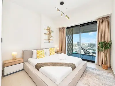 a bedroom with a large bed and a large window at Premium 2BD with Balcony Pool & Gym in Dubai