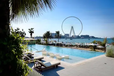 a swimming pool with a ferris wheel in the background at Luxurious 2BDR W Amazing Marina View & Large Patio in Dubai