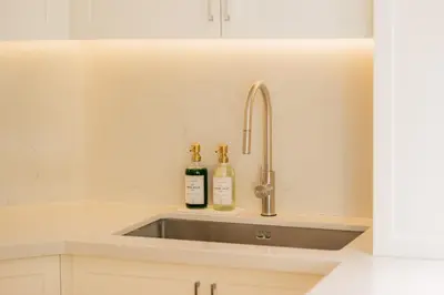 a kitchen sink with two bottles of wine at Dubai Marina - Beautiful 2 Bedroom Apartment in Dubai