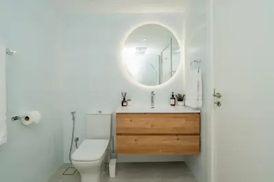 a bathroom with a toilet and a sink with a mirror at Dubai Marina - Beautiful 2 Bedroom Apartment in Dubai
