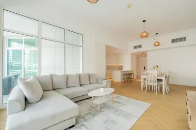 a living room with a white couch and a table at Dubai Marina - Beautiful 2 Bedroom Apartment in Dubai
