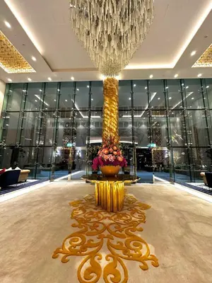 a large lobby with a large chandelier and a large vase at Premium Studio Burj Khalifa & Canal View in Dubai