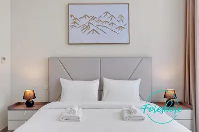 a bedroom with a large white bed with mountains at Ultra Luxury Villa 5BR With Maid Room in Dubai