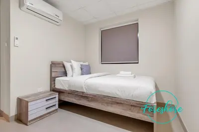 a bedroom with a bed with a board on the wall at Ultra Luxury Villa 5BR With Maid Room in Dubai