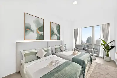 a living room with two beds and a couch at Golden Stays - Burj View Downtown Near Dubai Mall Sleeps 11 in Dubai
