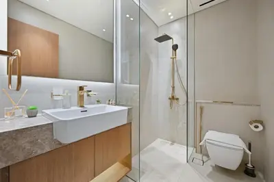 a bathroom with a sink and a toilet and a shower at Golden Stays - Private Pool Modern 2BR Oasis in JVC in Dubai