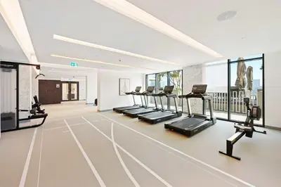 a gym with a row of treadmills and ellipticals at Silkhaus Luxurious 1BDR with Sea View in Emaar in Dubai