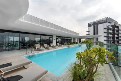 a swimming pool on the roof of a building at Arjan's Chic Studio with Cinema and Game Room in Dubai