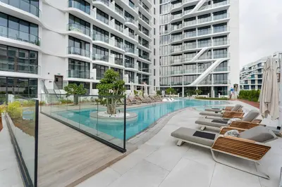 a swimming pool in the middle of a building at Arjan's Chic Studio with Cinema and Game Room in Dubai