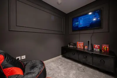 a living room with a couch and a flat screen tv at Forte 3BR Luxury PS5 Gaming Room Sleeps 9 in Dubai