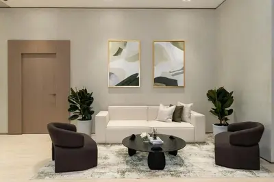 a living room with a white couch and two chairs at Stylish Stay with Plunge Pool & Scenic Pool View in Dubai