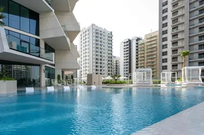 a large swimming pool in a building with tall buildings at Stylish Stay with Plunge Pool & Scenic Pool View in Dubai