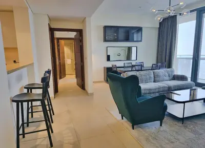 a living room with a couch and a table and chairs at Burj VIsta 3 Bedroom - With spectacular Views in Dubai