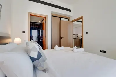 a bedroom with two white beds and a mirror at Binghatti House, JVC - 1 Bedroom Apartment - Allsopp & Allsopp in Dubai