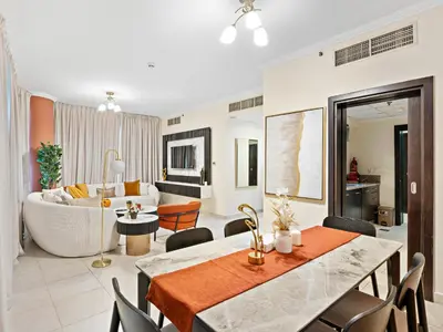 a living room with a couch and a dining room at Charming and Vibrant Living 1BDR In Marina Quay in Dubai