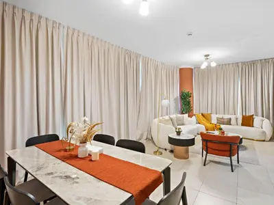 a living room with a table and chairs and a couch at Charming and Vibrant Living 1BDR In Marina Quay in Dubai