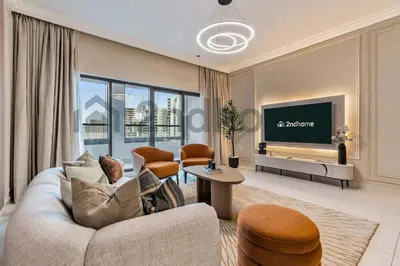 a living room with a couch and a tv at Business Bay Fully Equipped 2 Bedroom Capital Bay in Dubai