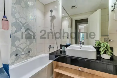 a bathroom with a white sink and a bath tub at Business Bay Fully Equipped 2 Bedroom Capital Bay in Dubai