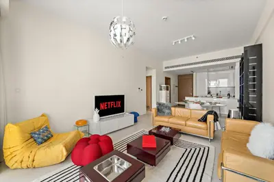 a living room with two couches and a tv at VayK - Elegant Canal-Front 1 BD in a Prime Location in Dubai