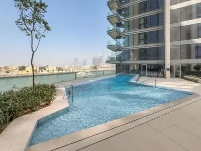 a swimming pool in the middle of a building at VayK - Elegant Canal-Front 1 BD in a Prime Location in Dubai