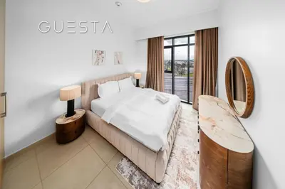 a bedroom with a large bed and a mirror at Vida The Hills Residences, Dubai in Dubai