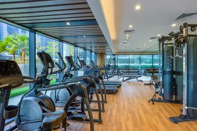 a gym with a row of treadmills and ellipticals at High Floor Unit with Canal View, A Minutes Drive to Dubai Mall - Zada Tower, Business Bay by Deluxe Holiday Homes in Dubai