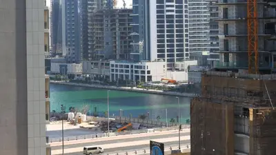 a view of a river in a city with buildings at Cozy 1BR in Business Bay, 10 mins to Metro in Dubai