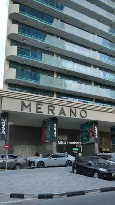 a meyero building with cars parked in front of it at Cozy 1BR in Business Bay, 10 mins to Metro in Dubai