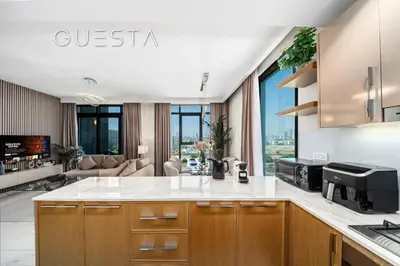 a kitchen and living room with a couch at Azizi Greenfield, Meydan Dubai in Dubai