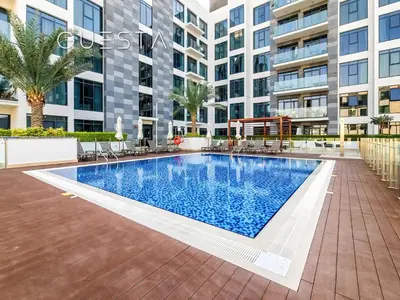 an image of a swimming pool in front of a building at Azizi Greenfield, Meydan Dubai in Dubai